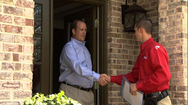 an EMC contractor greets a customer